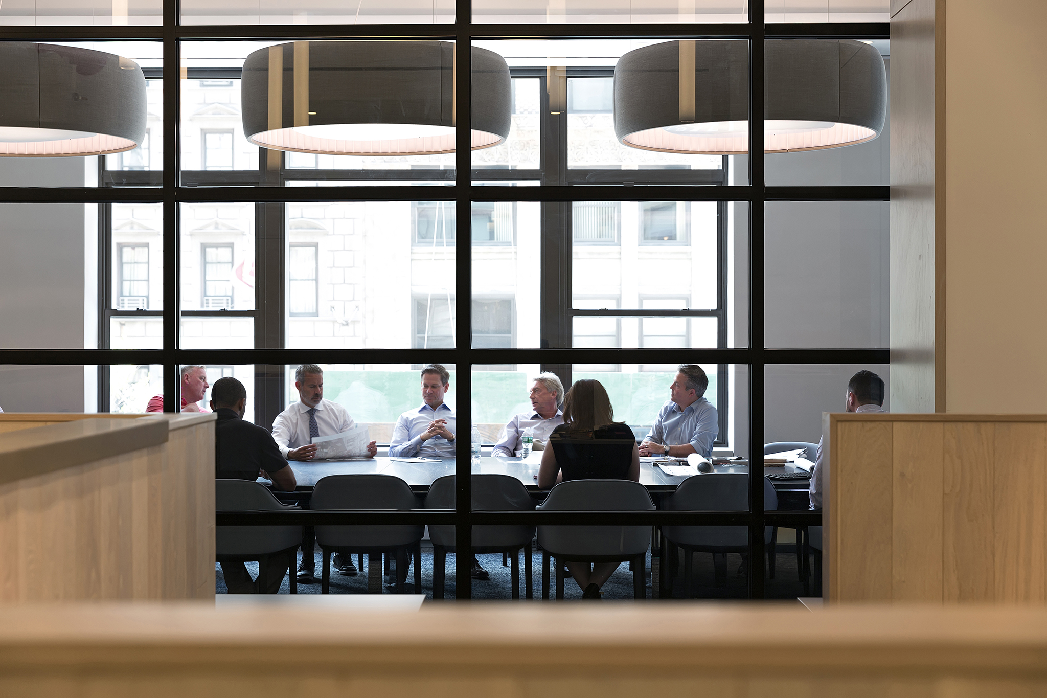 The Huddled executives chat about the days to come. corporate lifestyle photographer NY. 